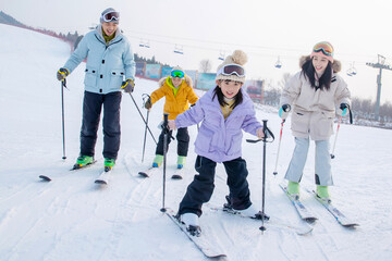 young parents and children ski in ski resort
