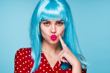 joyful woman in purple wig glamor posing blue background