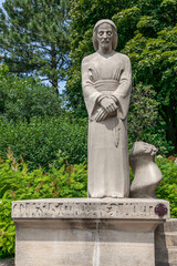 Fototapeta premium Statue of Jesus with hands folded and contemplative eyes in the garden of the St Joseph oratory, Montreal, Quebec, Canada