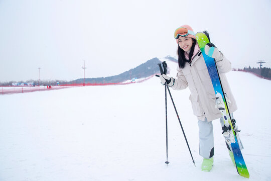 Enjoyment of a young woman ski on the snow
