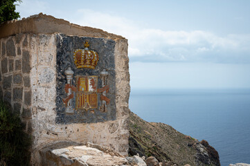 Shield of Spain engraved in the stone of an old defensive post