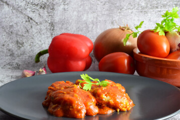 Close up. Cod with tomato sauce, garlic, parsley and other ingredients.
