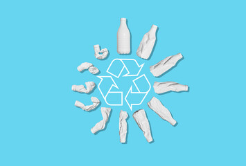 Recycling of plastic waste. A white plastic bottle is deformed against an empty blue background....