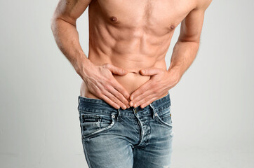 Mid adult man having stomach ache, close up