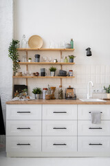 Wooden shelves in scandinavian kitchen interior design