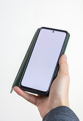 A smartphone in a case in a man's hand, isolated on a white background with a blank screen (clipping contour) for the layout and template of a digital mobile smartphone. Selective focus