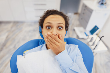 Afraid woman sitting in dental chair