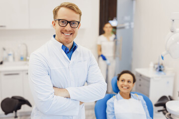 Obraz premium Dentist posing at camera with patient