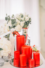 the focus of Christmas red candles and white roses