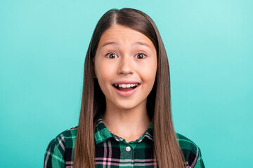 Fototapeta premium Photo of shiny impressed schoolgirl wear plaid outfit open mouth smiling isolated turquoise color background