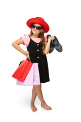 Stylish pretty little girl, charming kid standing with multicolored shopping packages and talking on phone isolated over white background.