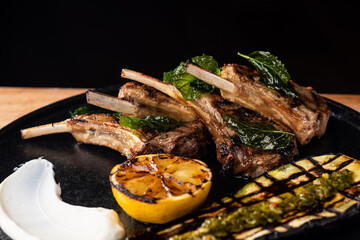 Fine dining, roasted Lamb chops with potato, lemon, rosemary and vegetable sauce