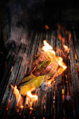 Beef T-bone steak on the grill with flames
