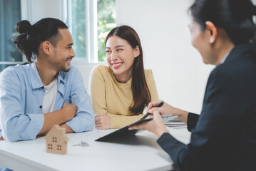 Realtor agent giving a key of apartment to new owner after signed lease agreement.