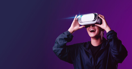 Teenage girls are having fun playing VR glasses virtual reality metaverse playing games, watching movies, listening to music, shopping. Colorful neon futuristic backgrounds, digital future technology 