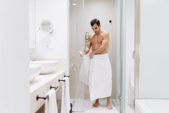 Mid adult man wearing towel after having bath