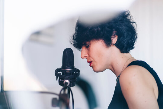 Female singer recording in studio