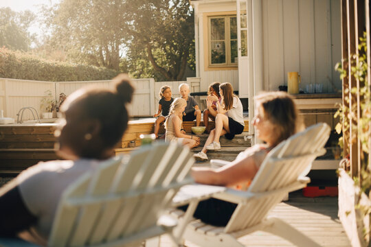 Children and mothers spending leisure time at patio on sunny day