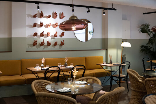 Hand sign models on wall with dining table in restaurant