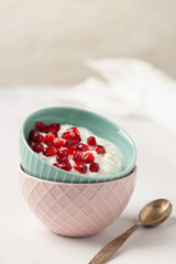 Cottage cheese with pomegranate grains in a bowl on the table. Healthy breakfast