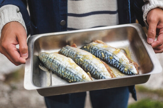 Midsection of man holding fish tray