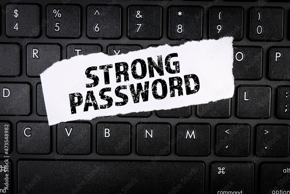 Sticker strong password. torn paper on a black computer keyboard