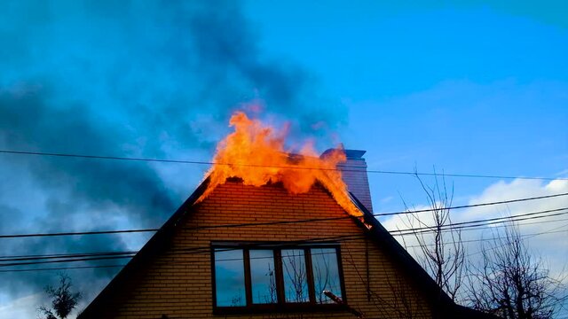 The roof of the house is on fire. Selective focus.