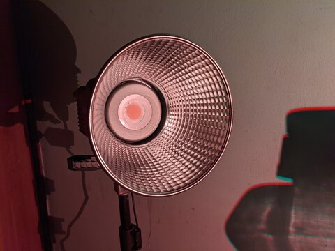  A black led video flash light on a tripod in a studio 
