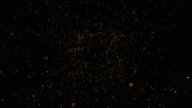 4k Gold Particles Explosion. Xmas Motion Background. Golden glitter particle. Isolated on black. Animated Overlay. 2022 New Year. 