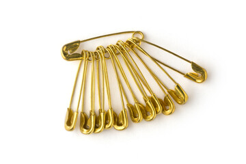 gold color safety pins, commonly used to fasten clothing, isolated on white background