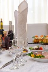 Beautiful table served with glassware and cultery, prepared for festive event.