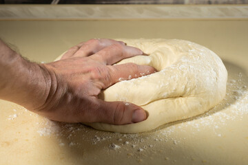 Fototapeta premium preparing the dough with your hands for baking