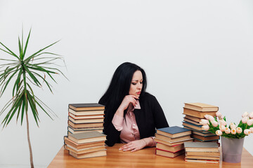 female teacher at a table with books for teaching