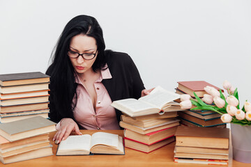 female teacher at a table with books for teaching