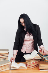 female teacher at a table with books for teaching