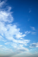 Fototapeta premium Artistic blue sky with curly clouds natural background