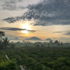 sunrise over the mountains in village farm