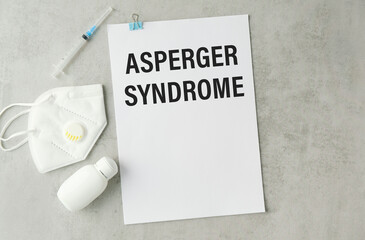 Doctor keeps a card with the name of the diagnosis -asperger syndrome. Selective focus. Medical concept.