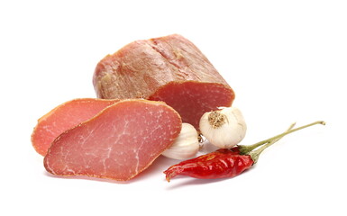 Smoked pork loin slices, hot red pepper and garlic isolated on white
