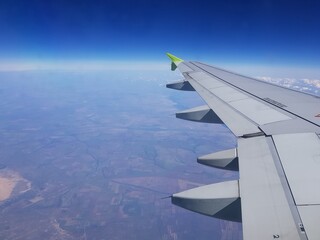 The plane is flying in the blue sky