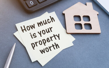 How Much is Your Property Worth Text on tablet device on a wood