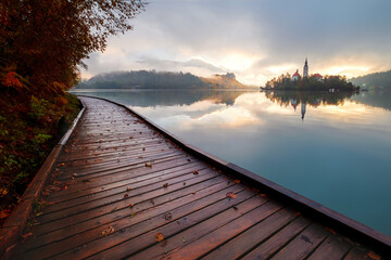 Autumn misty landscape at Lake Bled, in the middle of the lake with the church on it, in the Julian Alps, Triglav National Park