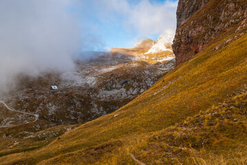 Autumn cloudy landscape near the Mangart Mountains along the Italian-Slovenian border in the Julian Alps