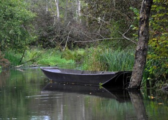 Old fishing boat in an early Autumn landscape in the Taubergiessen Nature conservation area  along the river Rhine in the Ortenau region of Baden Germany