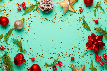 Christmas composition with decorations and ornaments on a mint background