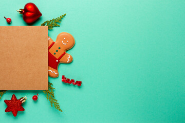 Christmas composition with decorations and cookies on a mint background with space for text