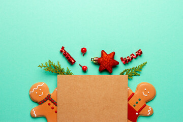 Christmas composition with decorations and cookies on a mint background with space for text