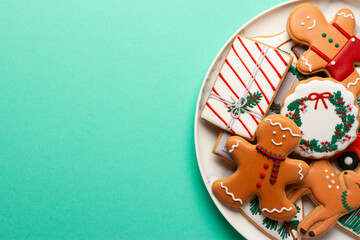 Christmas composition with decorations and cookies on a mint background