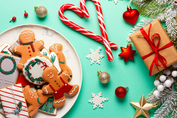 Christmas composition with decorations and cookies on a mint background