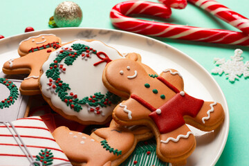 Christmas composition with decorations and cookies on a mint background